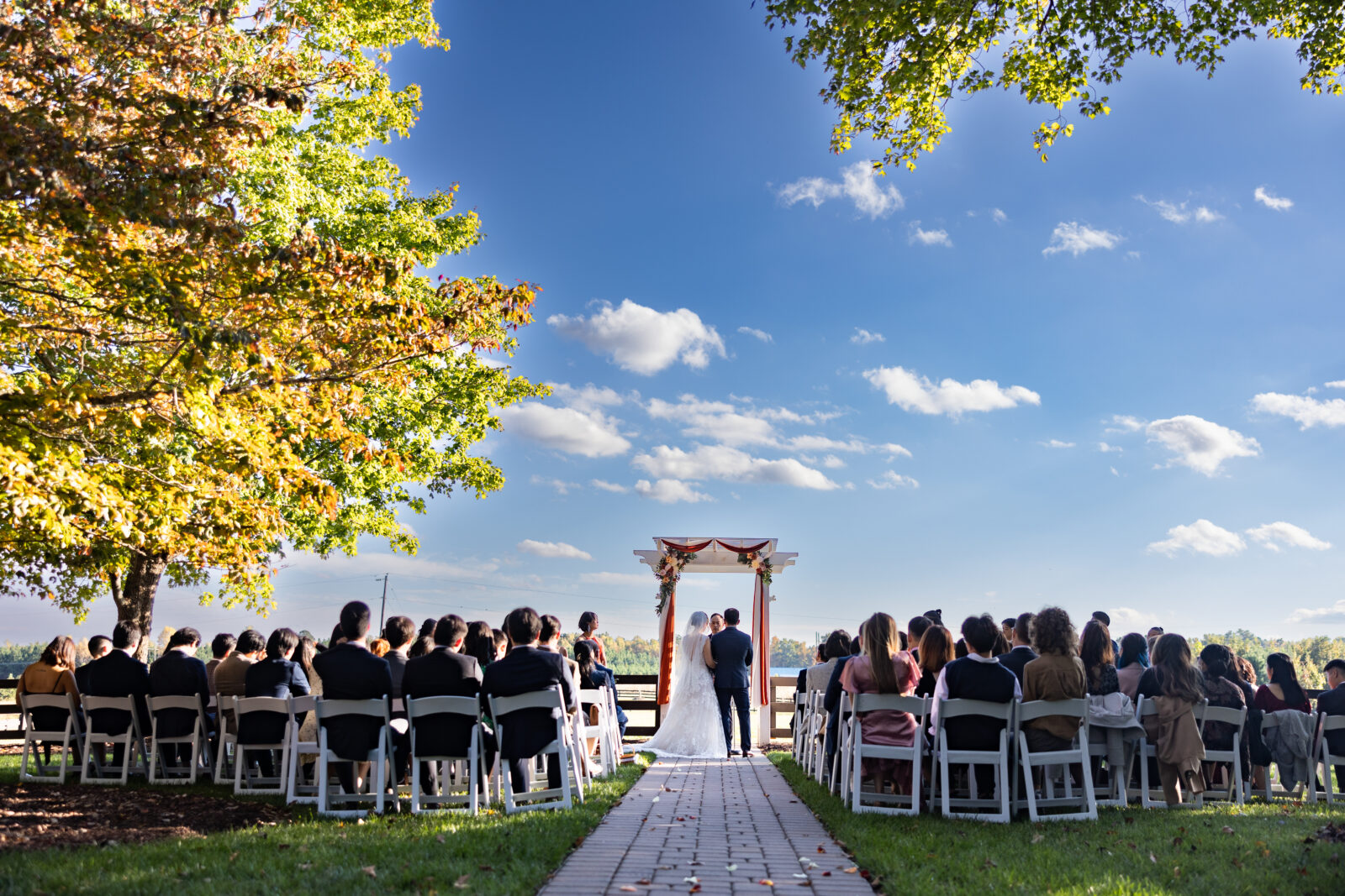 October ceremony outside on the lawn of Tranquility estates in Oxford NC under a blue sky